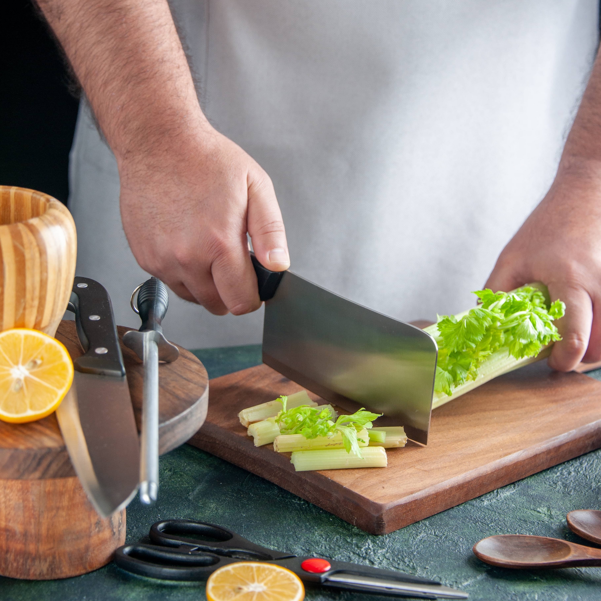 front-view-male-cook-cutting-celery-dark-table-salad-diet-meal-color-wisdom-school-mr-hamid-ziyane-ausbildung-fez-koch